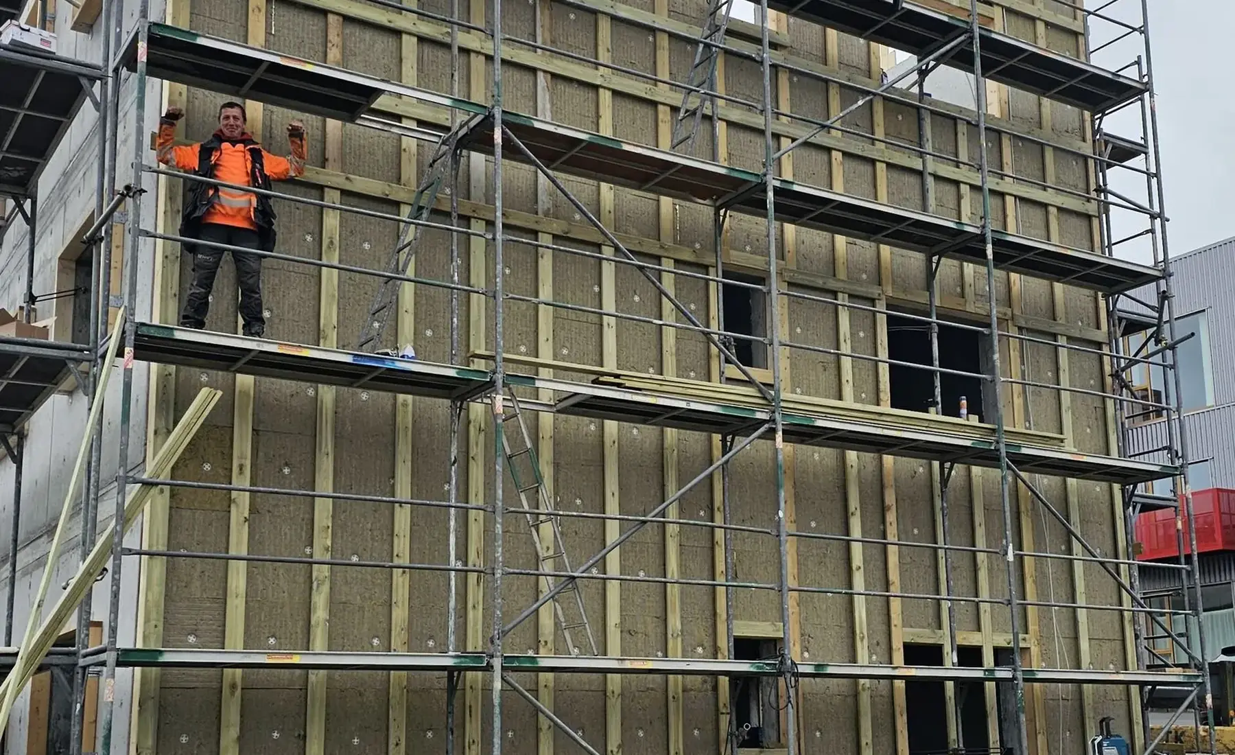 STERK crew installing a timber façade on scaffolding in the Faroe Islands