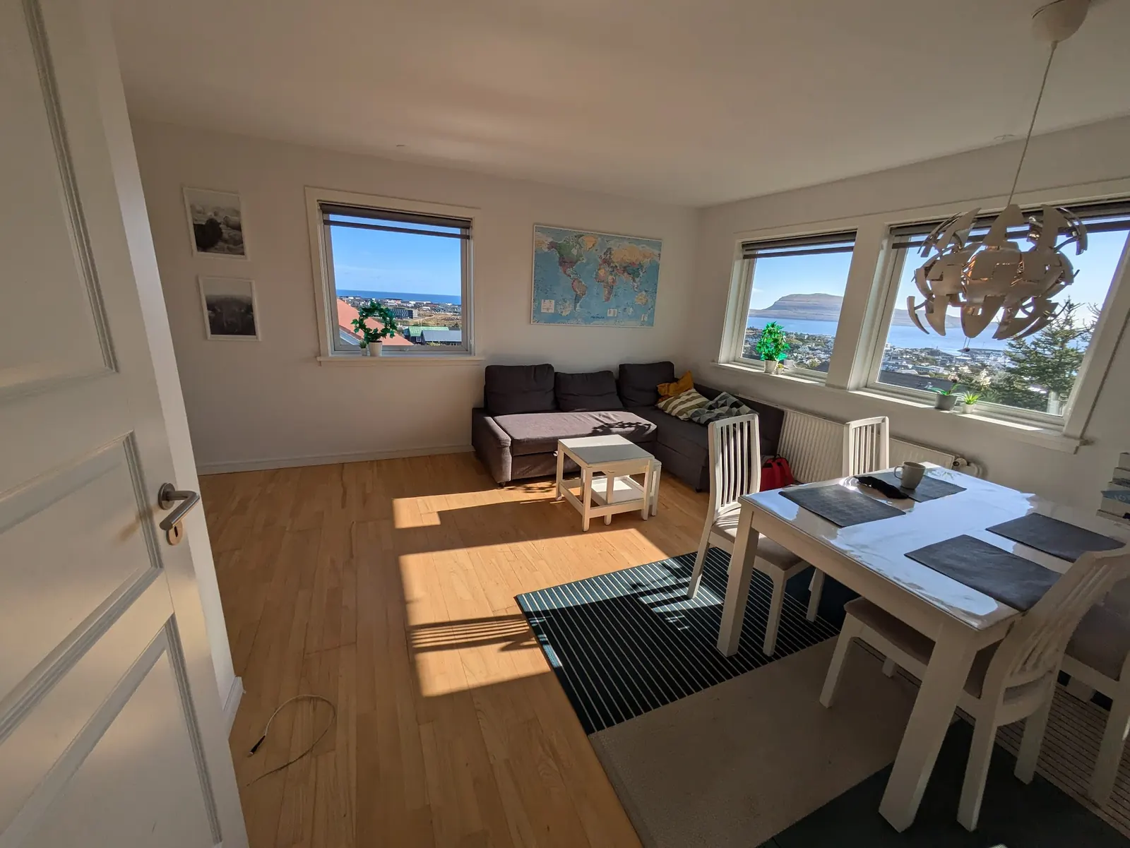 Furnished living room and kitchen in a shared 2-person apartment used for STERK placements, with a view over the town and the sea